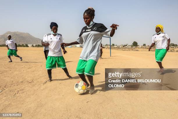 Nigerian refugee girls train during a session at the football pitch in the Minawao Refugee camp in Maroua, on January 16, 2022. - The girls, ranging...