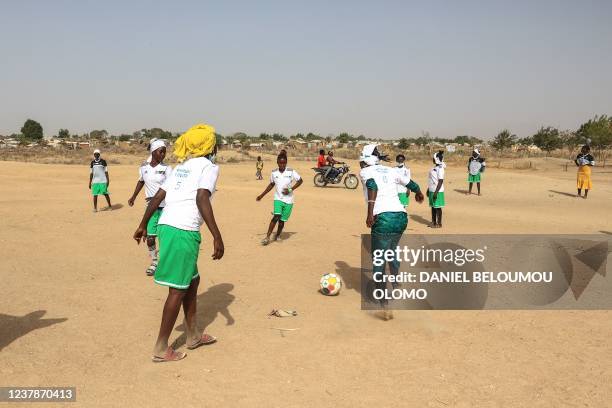 Nigerian refugee girls train during a session at the football pitch in the Minawao Refugee camp in Maroua, on January 16, 2022. - The girls, ranging...