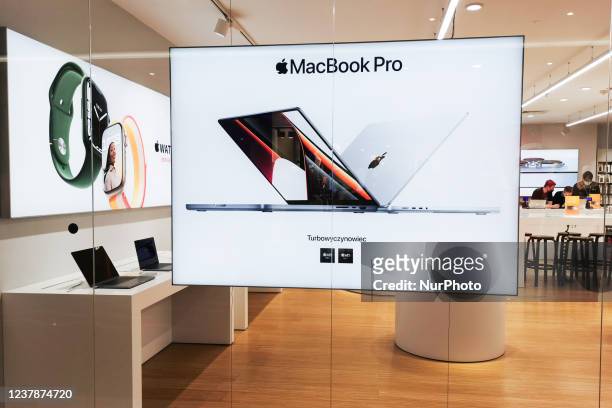 MacBook Pro ad is seen at ISpot store inside Galeria Krakowska shopping mall in Krakow, Poland. January 20, 2022.