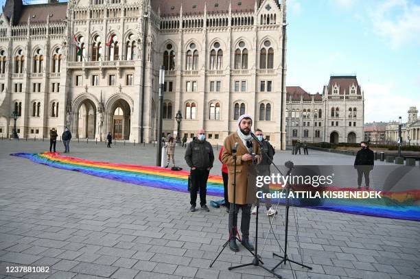 The organizer of Budapest Pride Parade, Mate Hegedus addresses a press conference as LMBTQ activists display a 30-meter-long rainbow-colored flag in...