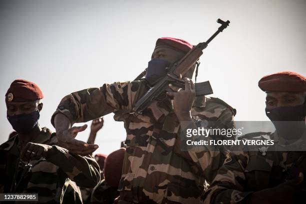 Soldier straps on his weapon during the state funeral of Mali's recently deceased ousted President Ibrahim Boubacar Keita, in Bamako, on January 21,...