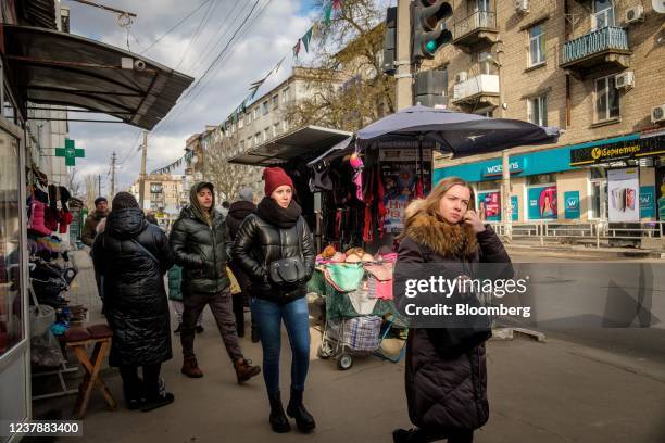 Pedestrians pass market stalls on a sidewalk in Kherson, Ukraine, on Thursday, Jan. 20, 2022. President Joe Biden said Russia will "pay a heavy...