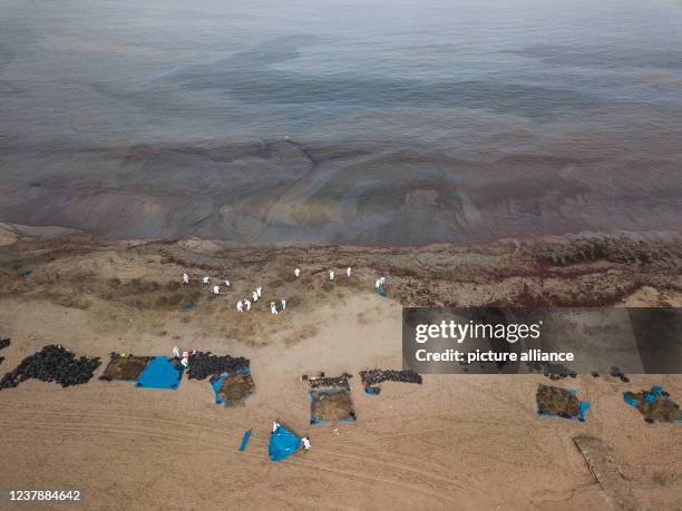 January 2022, Peru, Ancon: Units are engaged in cleaning up the beach and sea after an oil spill at the La Pampilla refinery, owned by the Spanish...