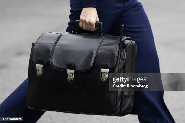 Military aide carries a briefcase containing codes for the nuclear arsenal following as U.S. President Joe Biden, not pictured, boards Marine One on...