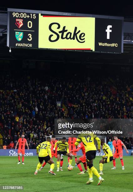 Match action beneath the big screens at Vicarage Road which show 15 minutes of added time following a problem with the floodlights which halted the...