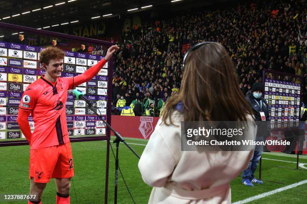 The Norwich crowd cheers as goalscorer Josh Sargent of Norwich waves to them during his post-match interview after the Premier League match between...