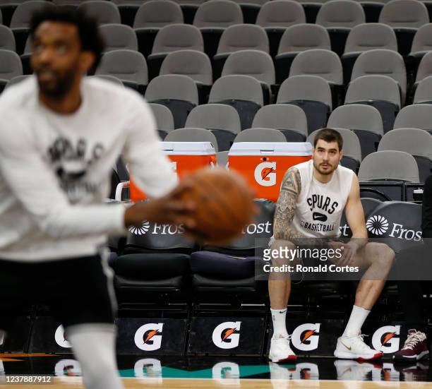 Juan Hernangomez of the San Antonio Spurs watches his new team warm up before their game against the Brooklyn Nets at AT&T Center on January 21, 2022...