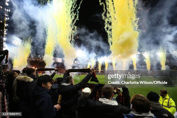 Fans hold their scarves aloft in honour of Sir Graham Taylors passing as flares and fireworks are set off at Vicarage Road ahead of the Premier...