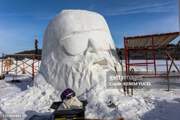 S House of Thune team's sculpture is seen next to it's model during the inaugural World Snow Sculpture Championship in Stillwater, Minnesota on...