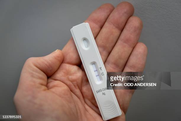 Used rapid antigen test, also known as a lateral flow test showing a positive test result for the Covid-19 coronavirus is photographed in Berlin on...