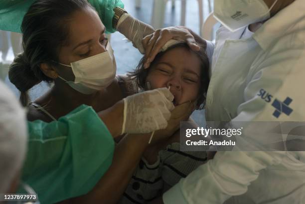 Children, babies and adults take the test to detect the new variant of the Coronavirus Omicron, the tests are being carried out in Favela do Alemao,...
