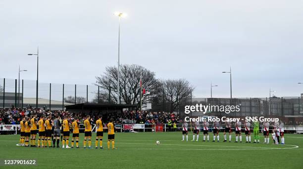 The players take part in a minute's applause during the Scottish Cup 4th round match between Clydebank and Annan Athletic at Holm Park, on January 22...