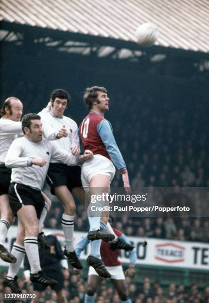 Geoff Hurst of West Ham United is outnumbered by Terry Hennessey, Dave Mackay and John Robson of Derby County during a Football League Division One...