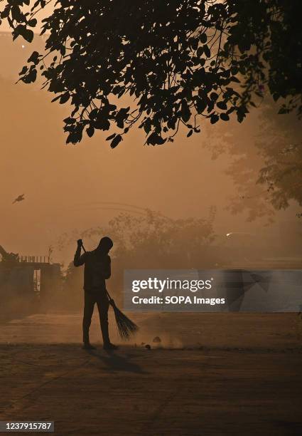 Sweeper cleans a Street early morning in Mumbai.