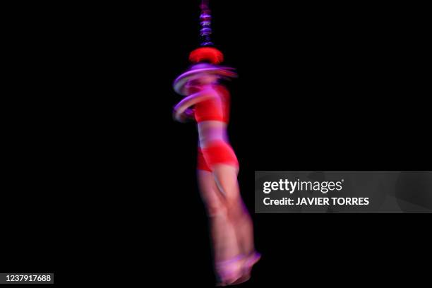 An artist of the French company Gratte Ciel performs 'Rouge!', an aerial and ground acrobatics show during the Santiago a mil 2022 Festival, in...