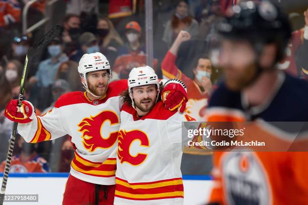 Noah Hanifin and Rasmus Andersson of the Calgary Flames celebrate a goal against the Edmonton Oilers during the first period at Rogers Place on...