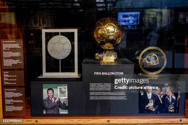 January 2022, Brazil, Santos: L-r: Player of the Century Trophy, received by Pelé in 2000. Golden Ball, award for Pelé in 2014. World Player Gala...