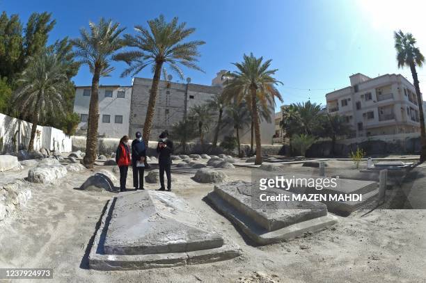 Ebrahim Nonoo , Head of the Jewish community in Bahrain, looks on as Rabbi Yaacov Phia prays over tombs at the Jewish cemetery in Bahrain's capital...