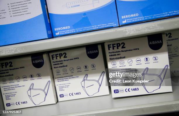 Face masks lay prepared for usage in boxes at a test and vaccination centre set up at a car dealership as the spread of the coronavirus disease...