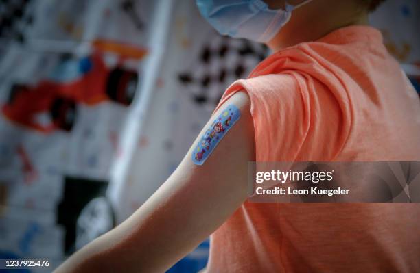 Boy is seen with a plaster on his arm after being vaccinated with the BioNTech/Pfizer vaccine dosed for children at a test and vaccination centre set...