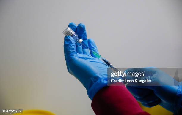 Member of the medical staff set up syringes with the BioNTech/Pfizer at a test and vaccination centre set up at a car dealership as the spread of the...