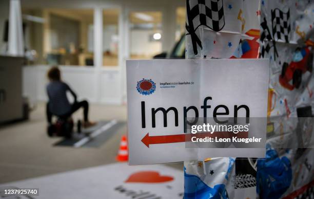 Sign which reads Vaccination is seen at a test and vaccination centre set up at a car dealership as the spread of the coronavirus disease continues...