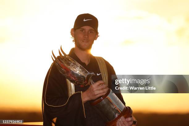 Thomas Pieters of Belgium poses with the trophy following his victory during Day Four of the Abu Dhabi HSBC Championship at Yas Links Golf Course on...