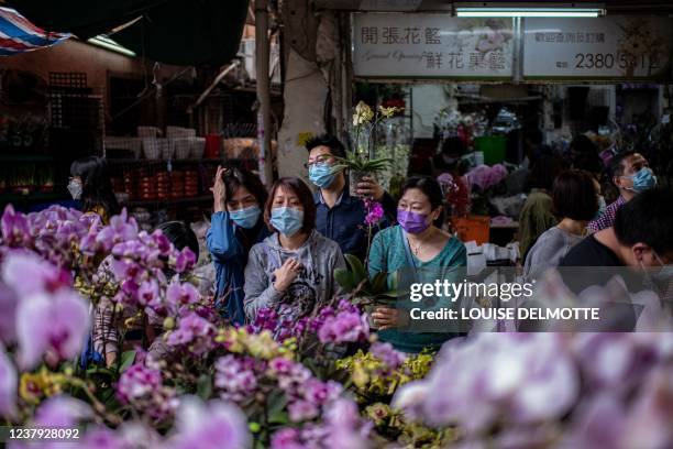 Shoppers purchase orchids at a flower market in Prince Edward district ahead of the Lunar New Year in Hong Kong on January 23, 2022.