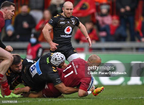 Limerick , Ireland - 23 January 2022; Simon Zebo of Munster scores his side's second try, as he's tackled by Nizaam Carr of Wasps, during the...