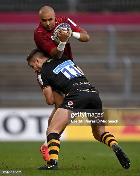 Limerick , Ireland - 23 January 2022; Simon Zebo of Munster is tackled by Josh Bassett of Wasps during the Heineken Champions Cup Pool B match...