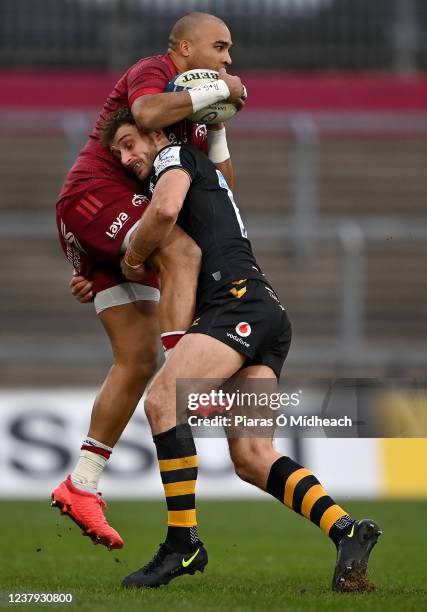 Limerick , Ireland - 23 January 2022; Simon Zebo of Munster is tackled by Josh Bassett of Wasps during the Heineken Champions Cup Pool B match...