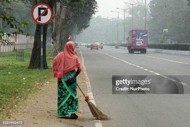Sweeper clean the Street amid smoggy conditions in Kolkata on January 23,2022.