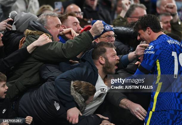 Supporters celebrate with Chelsea's English midfielder Mason Mount after team mate Chelsea's Brazilian defender Thiago Silva scored their second goal...