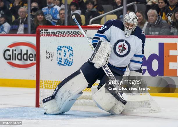 Winnipeg Jets Goalie Connor Hellebuyck makes a save during the first period in the NHL game between the Pittsburgh Penguins and the Winnipeg Jets on...