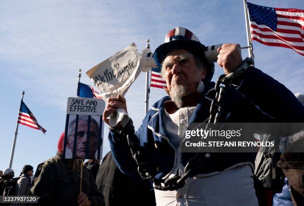 Demonstrator dressed as "Uncle Sam" takes part in a Defeat the Mandates march in Washington, DC, on January 23, 2022. - Demonstrators are protesting...