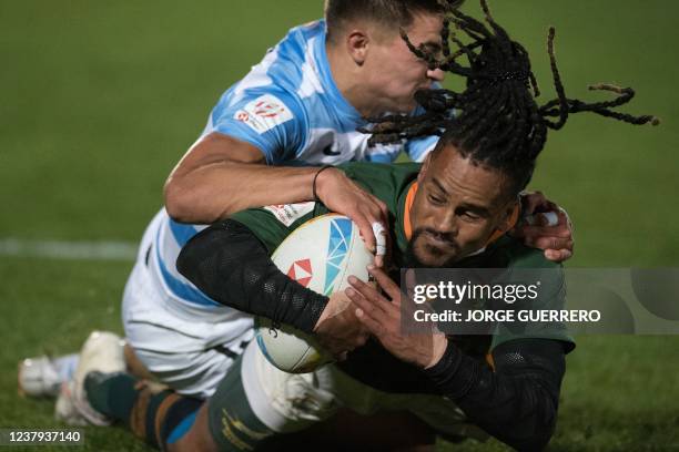 South Africas Selvyn Davids is tackled by Argentinas Marcos Moneta during the Men's HSBC World Rugby Sevens Series 2022 final match between Argentina...