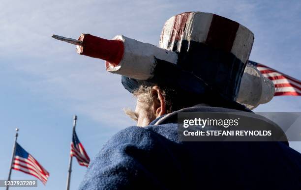 Demonstrator dressed as "Uncle Sam" takes part in a Defeat the Mandates march in Washington, DC, on January 23, 2022. - Demonstrators are protesting...