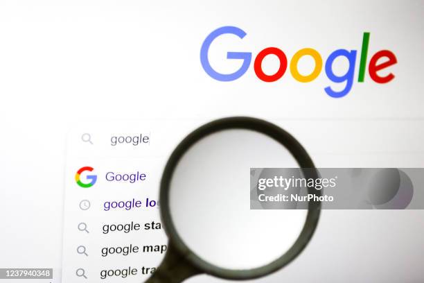 Magnifying glass is photographed with Google logo displayed on a laptop screen for illustration photo. Gliwice, Poland on January 23, 2022.