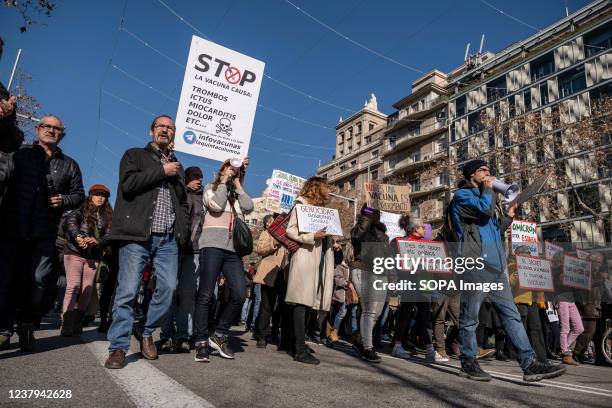 Protesters hold placards during the demonstration. Summoned by the Barcelona Coordinator against the Sanitary Dictatorship, hundreds of people have...