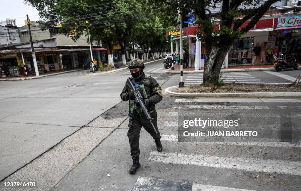 Member of Colombia's national police patrols the streets of Savarena, Arauca, Colombia, near the Venezuelan border on January 23, 2022. - Five people...