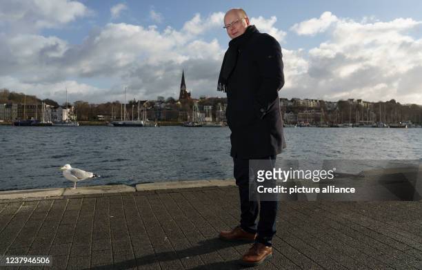 January 2022, Schleswig-Holstein, Flensburg: Stefan Seidler , the only member of parliament from the Südschleswigsche Wählerverband, stands in front...