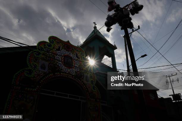 Backlight and exterior view of a church in the streets of San Antonio Culhuacán in Mexico City where the celebration of San Antonio Abad, patron...