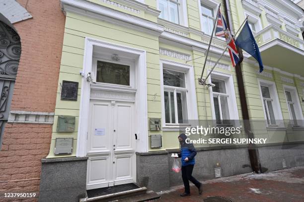 Man walks past the UK Embassy building in Kyiev on January 24, 2022. - Britain's foreign ministry said on January 24, 2022 it was withdrawing some...