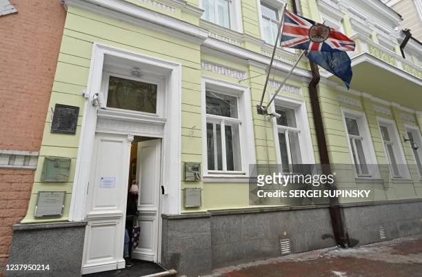 Woman comes out the UK Embassy building in Kyiev on January 24, 2022. - Britain's foreign ministry said on January 24, 2022 it was withdrawing some...