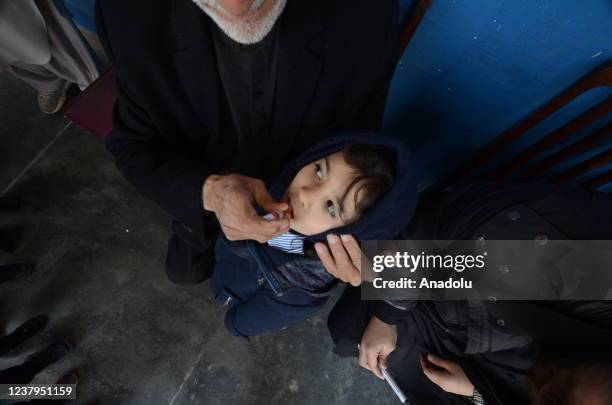 Health worker administers a polio vaccine to a child at a school in Peshawar, Pakistan, Monday. Pakistani authorities on Monday launched this year's...