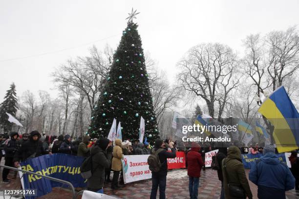 People attend a protest of opponents of vaccination against Covid-19 and quarantine measures in front of the Ukrainian Parliament in Kiev, Ukraine,...