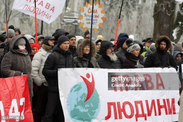 People attend a protest of opponents of vaccination against Covid-19 and quarantine measures in front of the Ukrainian Parliament in Kiev, Ukraine,...