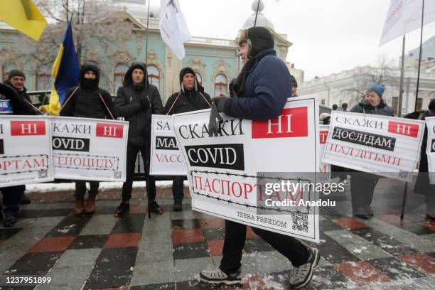 People attend a protest of opponents of vaccination against Covid-19 and quarantine measures in front of the Ukrainian Parliament in Kiev, Ukraine,...