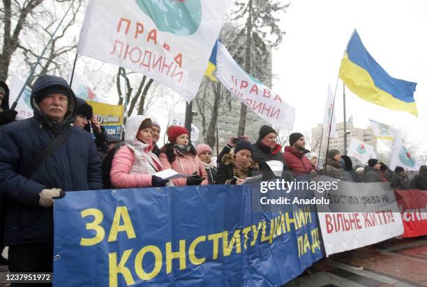 People attend a protest of opponents of vaccination against Covid-19 and quarantine measures in front of the Ukrainian Parliament in Kiev, Ukraine,...