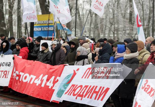 People attend a protest of opponents of vaccination against Covid-19 and quarantine measures in front of the Ukrainian Parliament in Kiev, Ukraine,...
